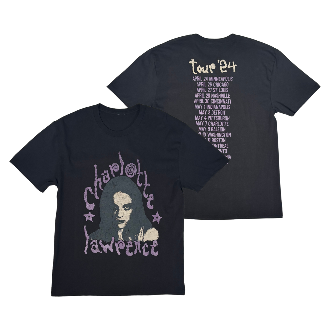 Two black short-sleeve T-shirts shown on a white background, with the front and back views overlapping. The front shirt features a large graphic of a woman's face with the words 'Charlotte Lawrence' in a purple stylized font.